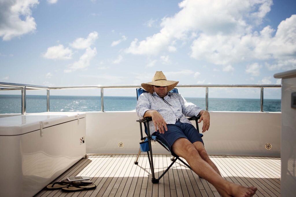 man relaxing on yacht N4MX3FD.jpg